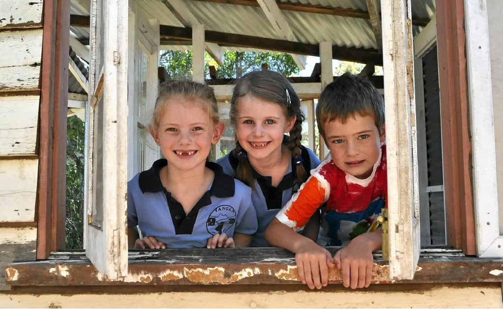 Bessie Eastwell, Gabby Kerlin and Jake Locke peek out the window of their new cubby at Yangan State School.